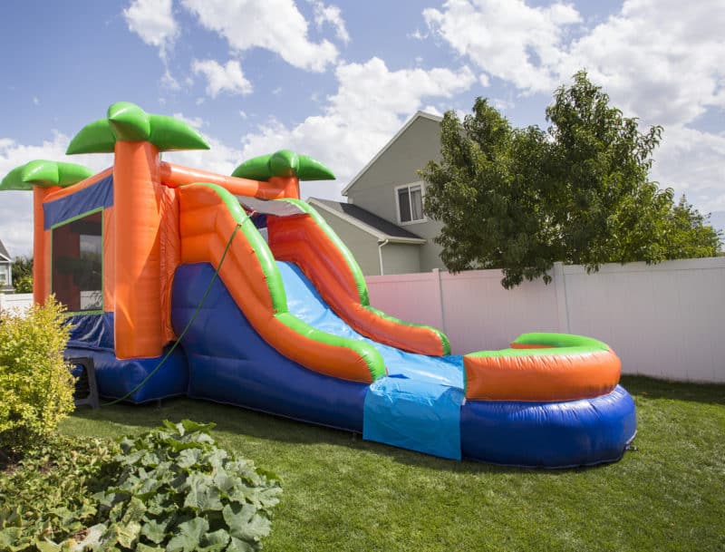 Inflatable bounce house water slide in the backyard | Australian Inflatables