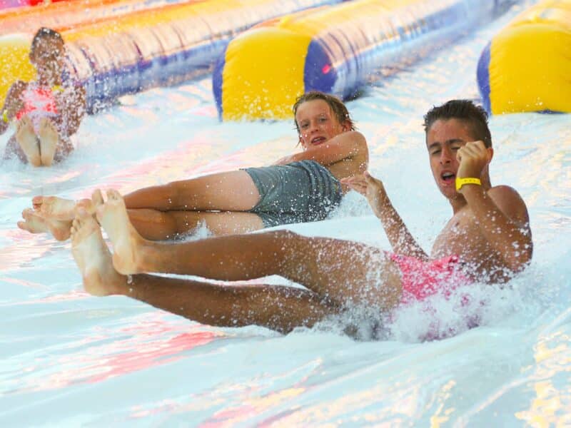 sliding on inflatable water slide | Australian Inflatables